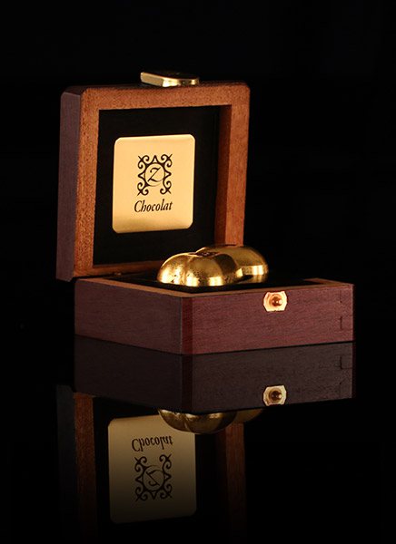 Chocolates coated with 24-karat edible gold in a mahogany box