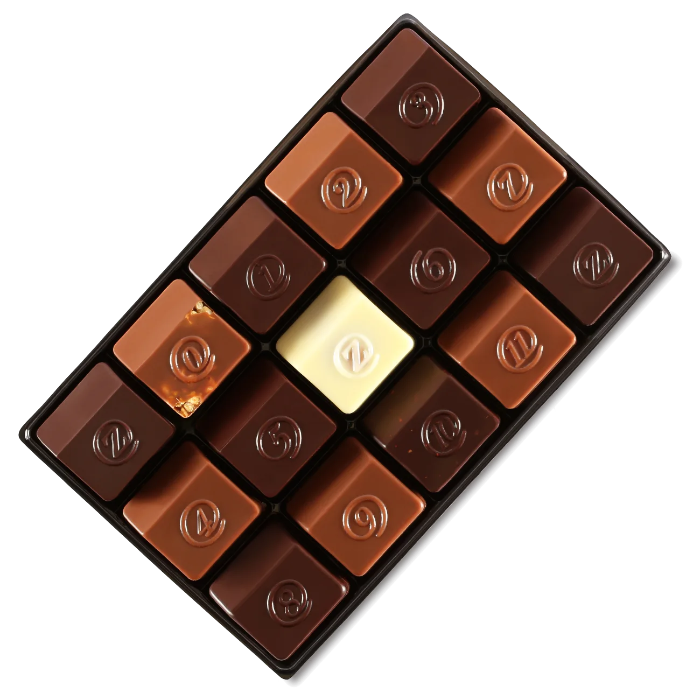 The open assortment tray of numbered chocolates